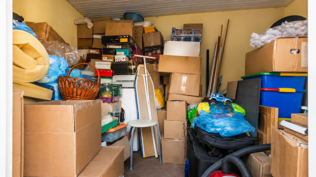 Cluttered estate storage room filled with boxes and household items before a professional cleanout in Brockton MA.